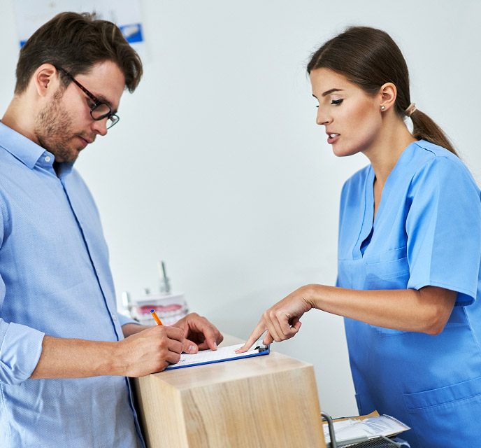 dentist and patient filling out paperwork
